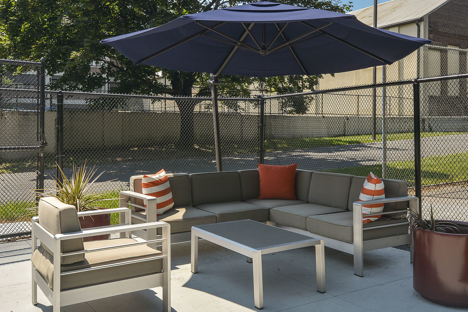 comfy seating area with blue umbrella for shade