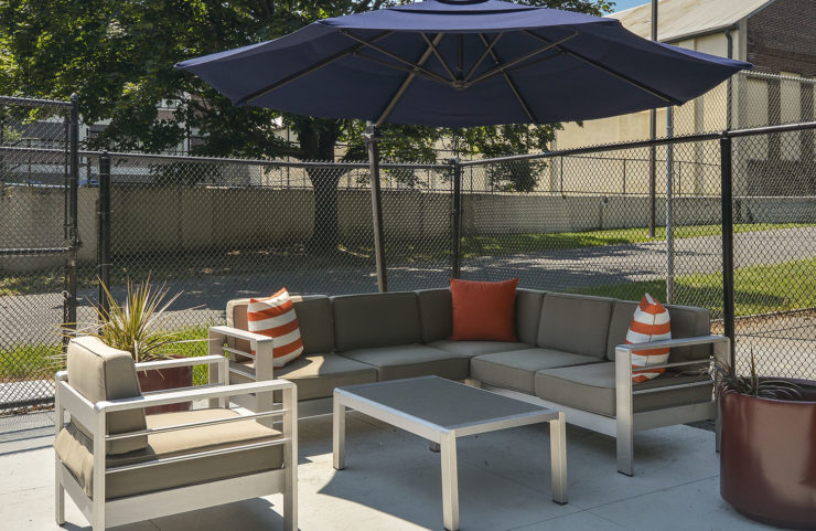 comfy seating area with blue umbrella for shade 