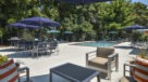 comfy chairs and tables near pool 