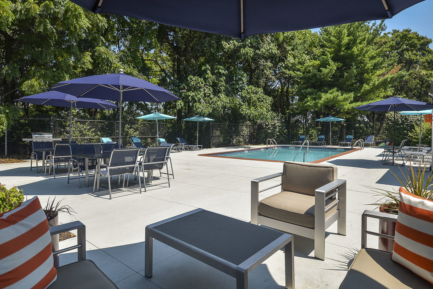 comfy chairs and tables near pool
