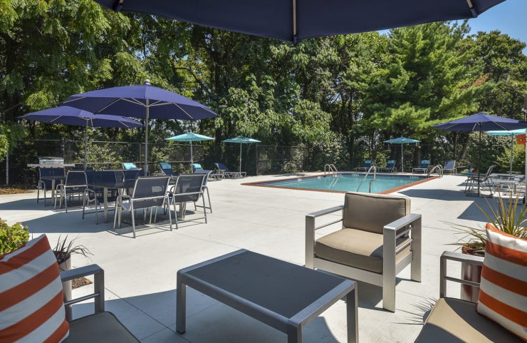 comfy chairs and tables near pool 