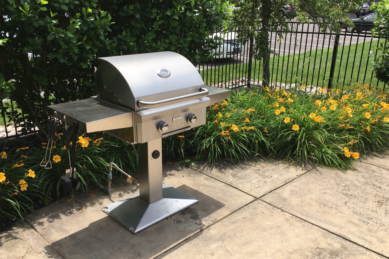 stainless steel grill surrounded by flowers 