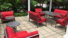 poolside pergola with red padded chairs 