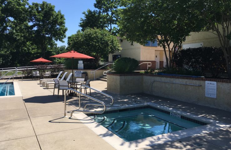 jacuzzi with umbrella tables in the background 
