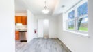 dining area with large window and plank flooring