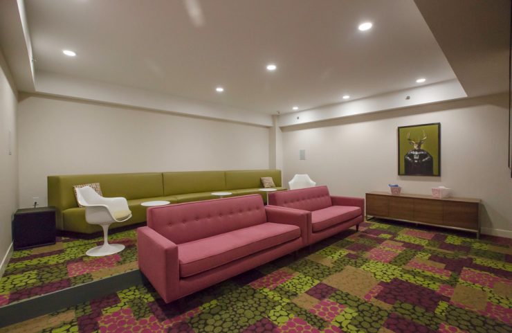 screening room with three large sofas and two chairs with tables 