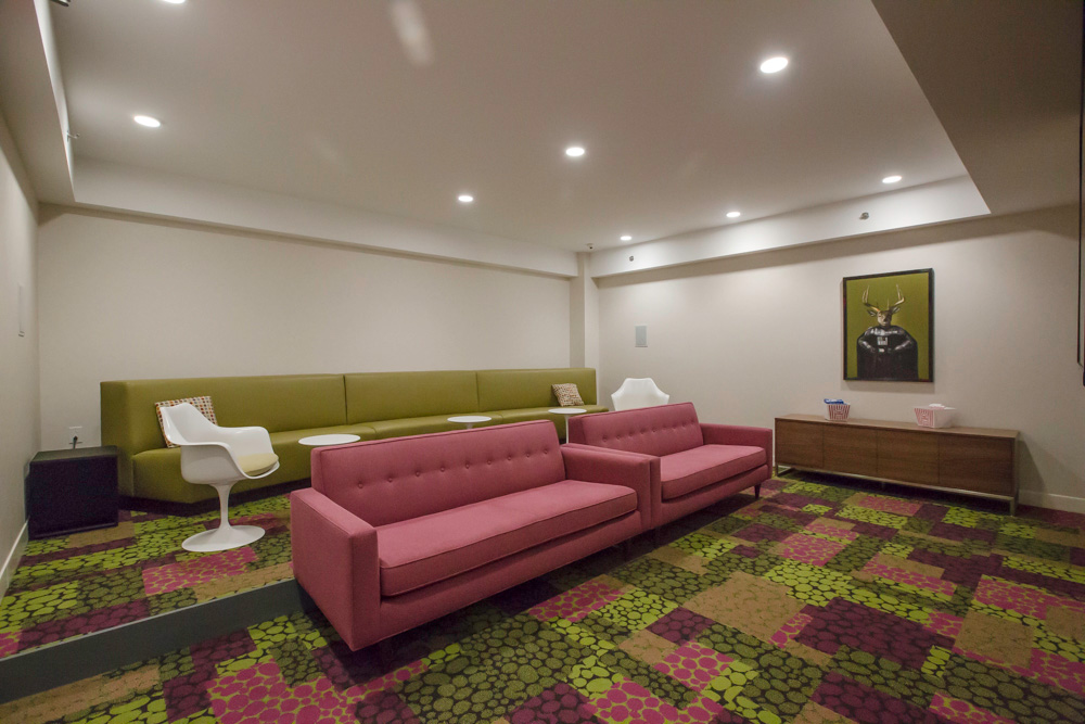 screening room with three large sofas and two chairs with tables