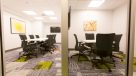 conference rooms with rolling chairs and tvs 