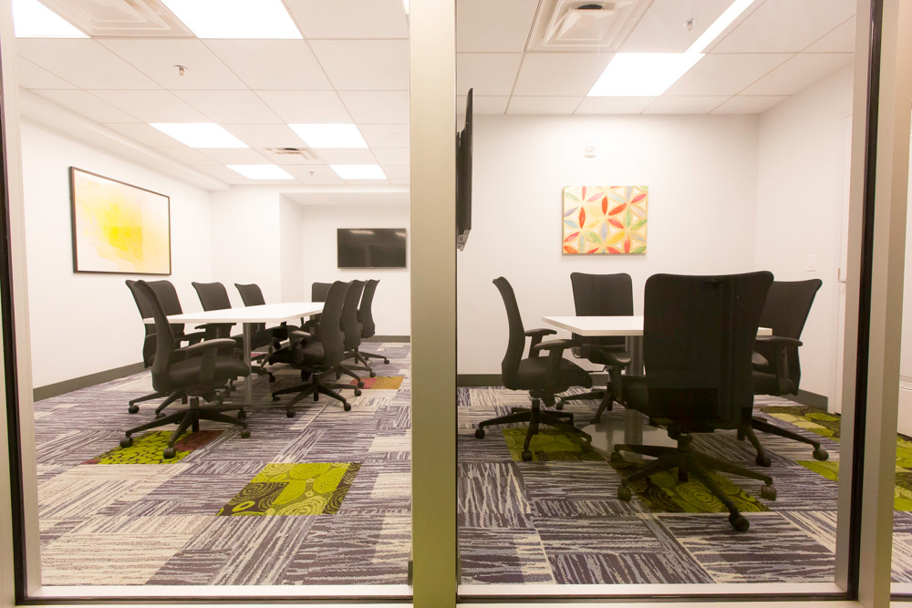 conference rooms with rolling chairs and tvs