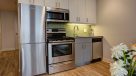 white kitchen cabinets with stainless steel appliances