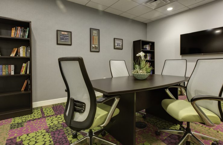 conference room with books to read and flat screen tv