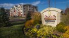 Entrance sign with apartments in the background 