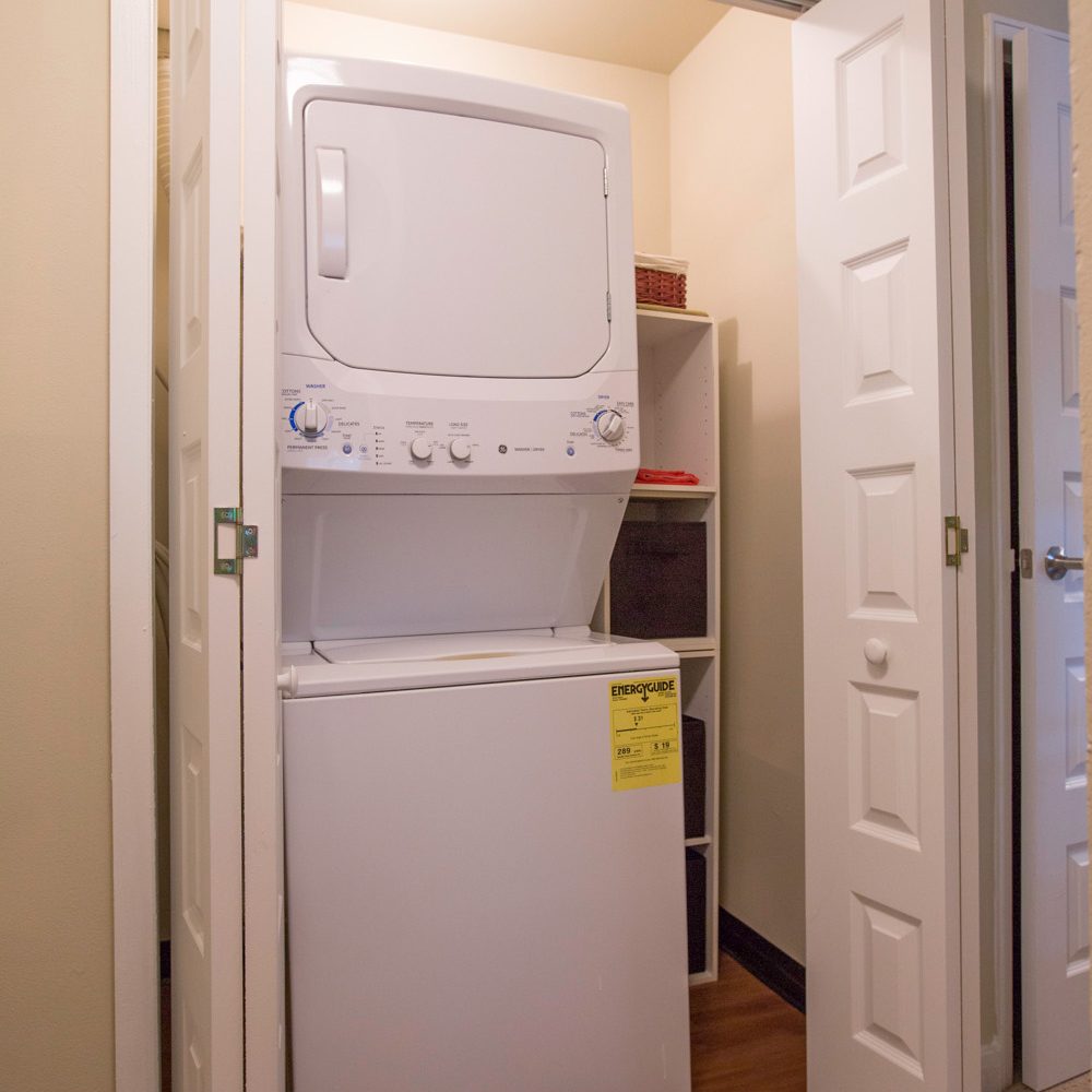 stackable washer and dryer in a roomy closet