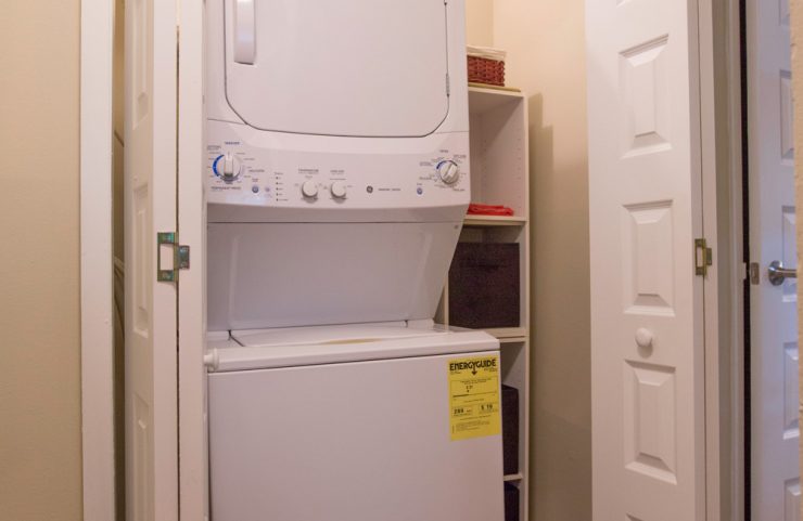 stackable washer and dryer in a roomy closet 
