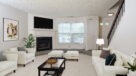 carpeted living room with a wood burning fireplace 