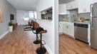 dining and kitchen with white cabinets 