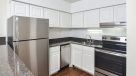 white cabinets with stainless steel appliances in updated kitchen