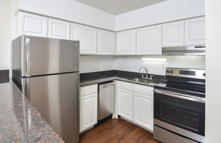 white cabinets with stainless steel appliances in updated kitchen