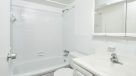 updated bathroom with white vanity and tub