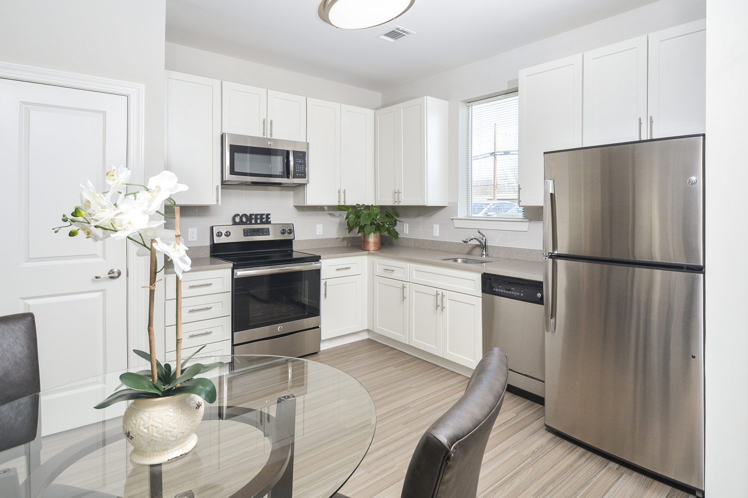 eat in kitchen with light vinyl plank flooring 