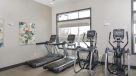 cardio machines in the fitness center overlooking the pool 