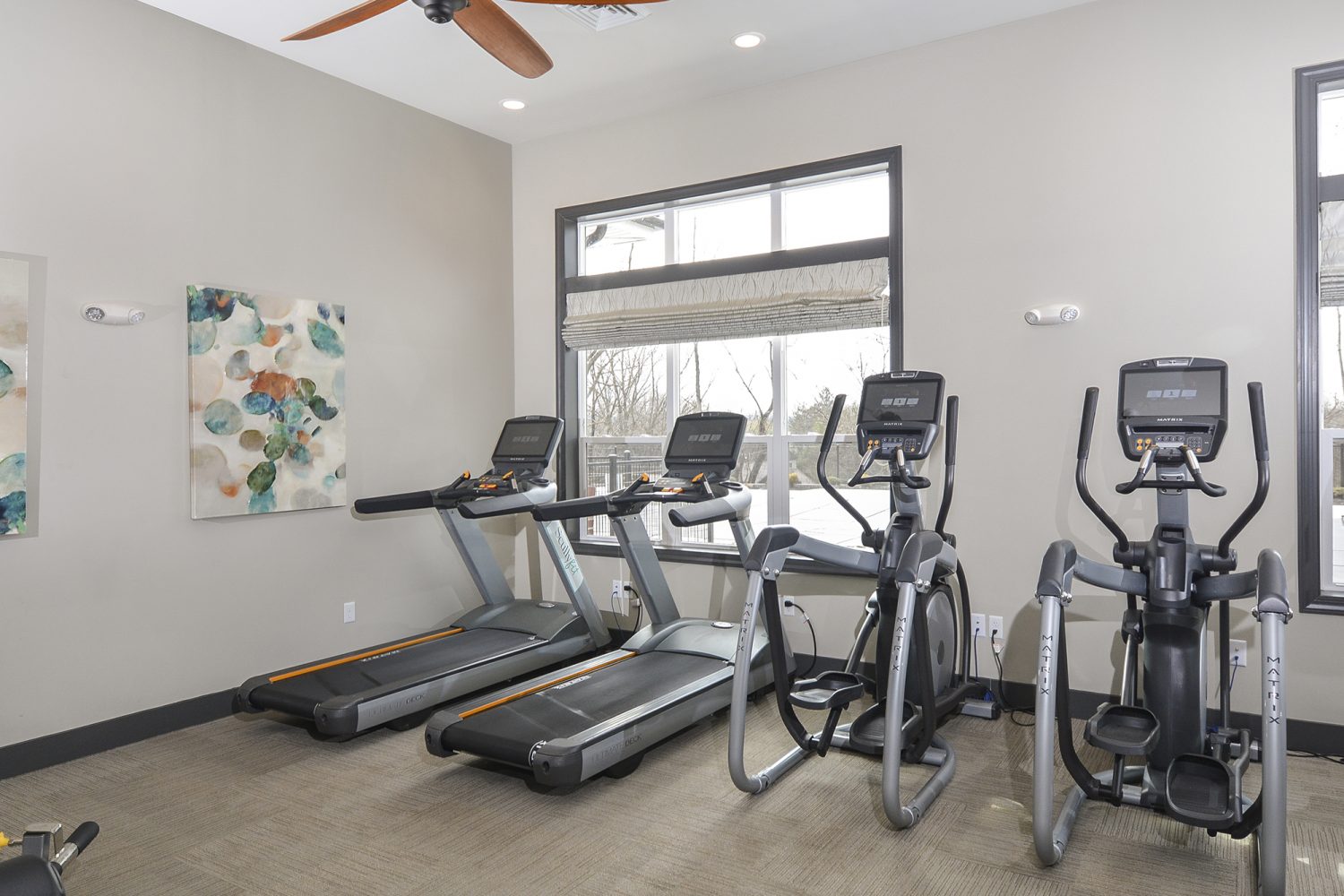 cardio machines in the fitness center overlooking the pool 