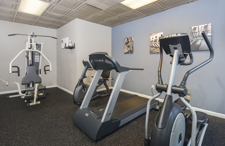elliptical, treadmill and weight machine in fitness center