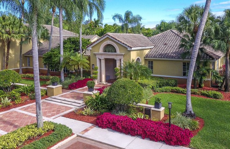 leasing office entrance with beautiful landscaping along walkway 