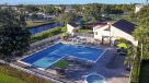 aerial photo of the pool and jacuzzi right next to a lake 