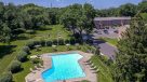 aerial view of outdoor pool with apartment in background 