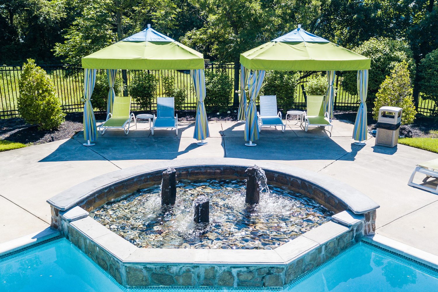 cabana area with fountain feature in pool 