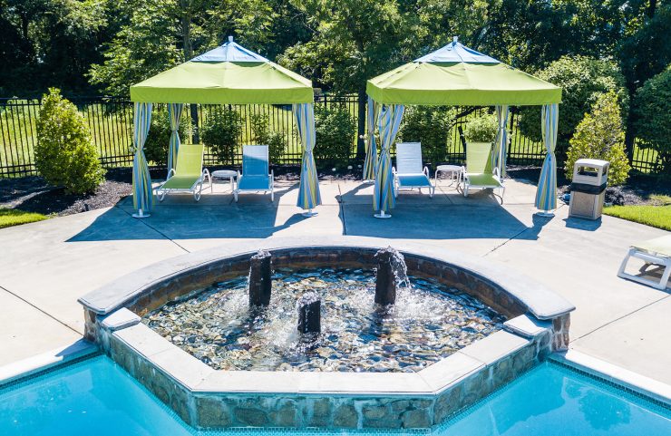 cabana area with fountain feature in pool 