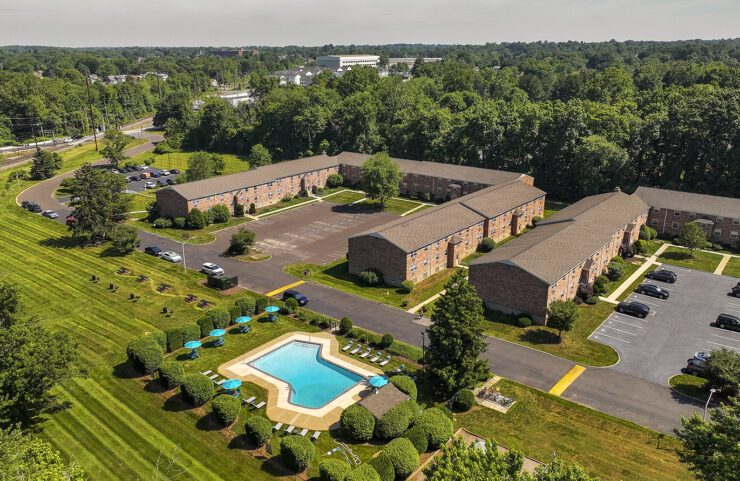 aerial view of outdoor pool with apartment in background
