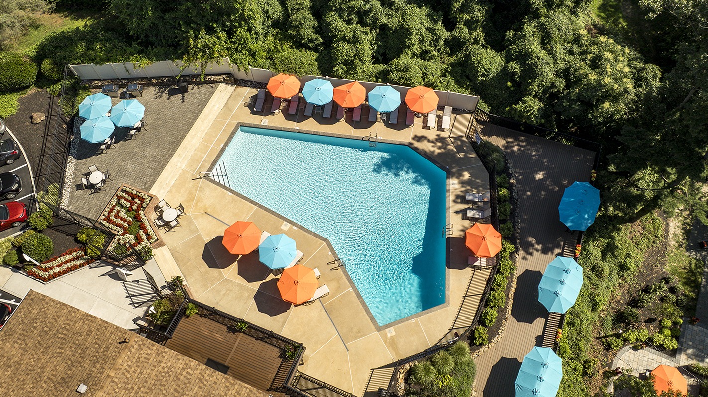Pool With Patio Furniture and Umbrella Tables