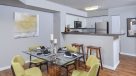 open kitchen into dining area with plank flooring 