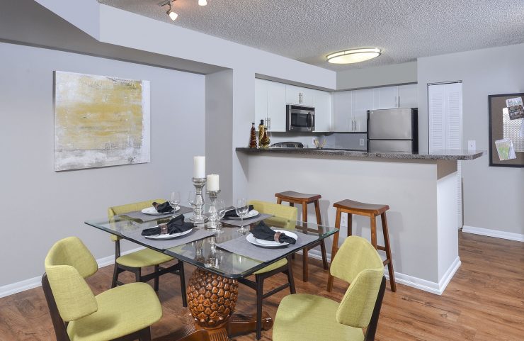 open kitchen into dining area with plank flooring 