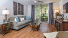 large living room with plank flooring and ceiling fan