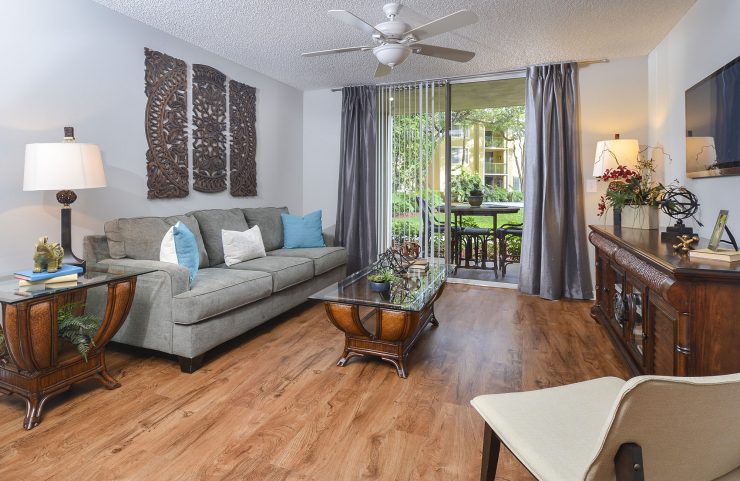 large living room with plank flooring and ceiling fan