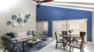 bright living and dining area with ceiling fan and tile floors