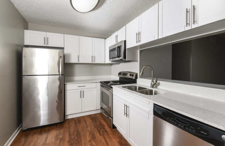 upgraded kitchen with white cabinets and stainless steel appliances