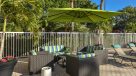 comfy seating area with umbrellas by the pool 