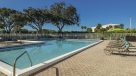 pool with lots of lounge chairs 