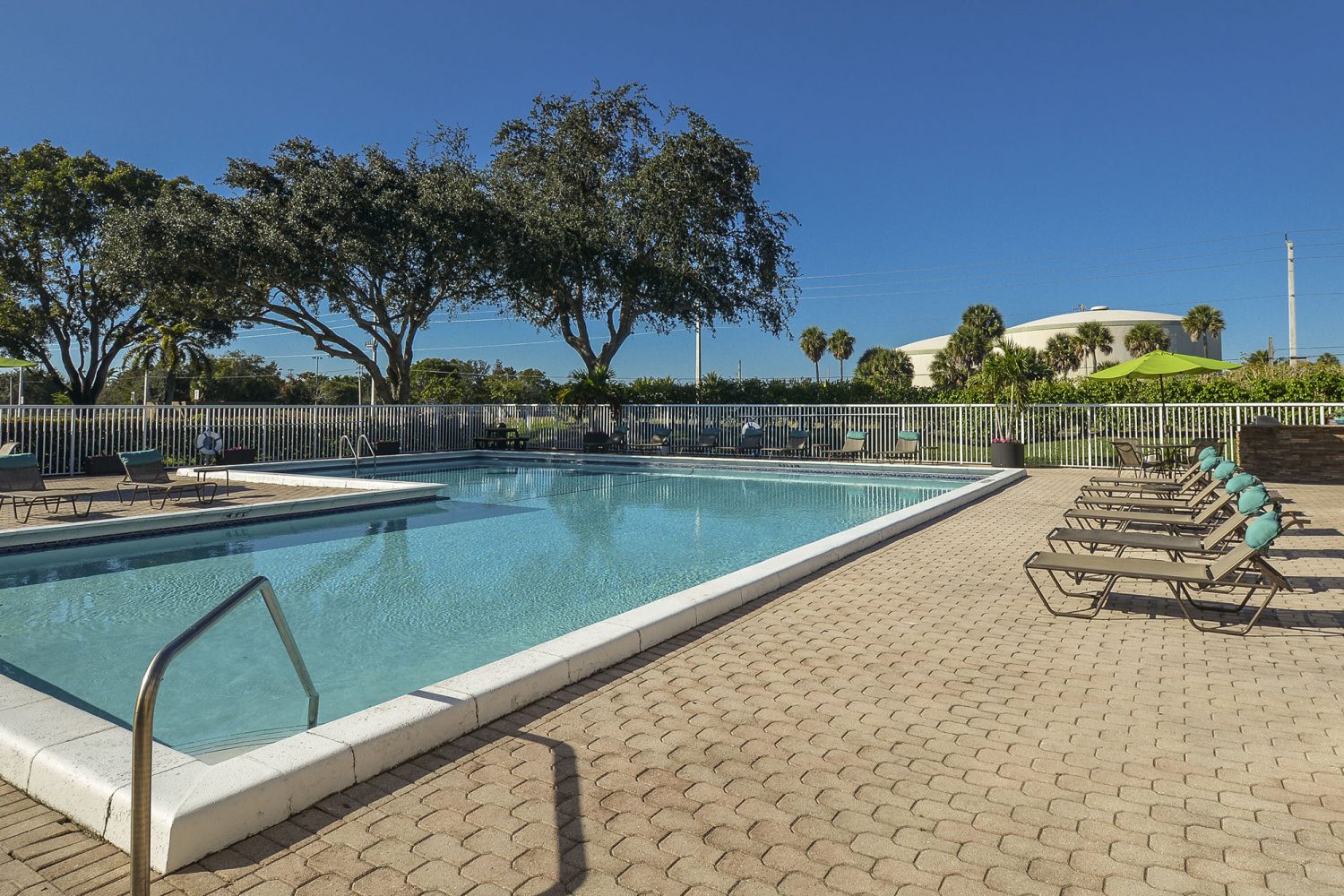 pool with lots of lounge chairs 