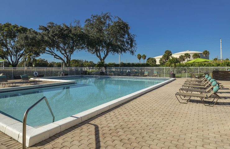 pool with lots of lounge chairs 