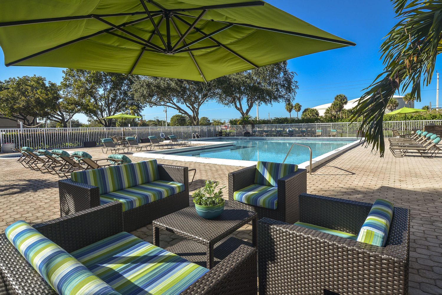 lime and blue padded seating area next to pool 