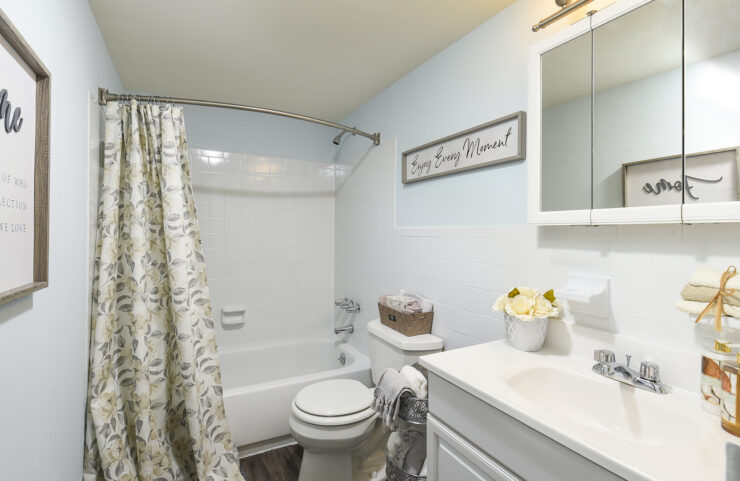 bathroom with white vanity and tub