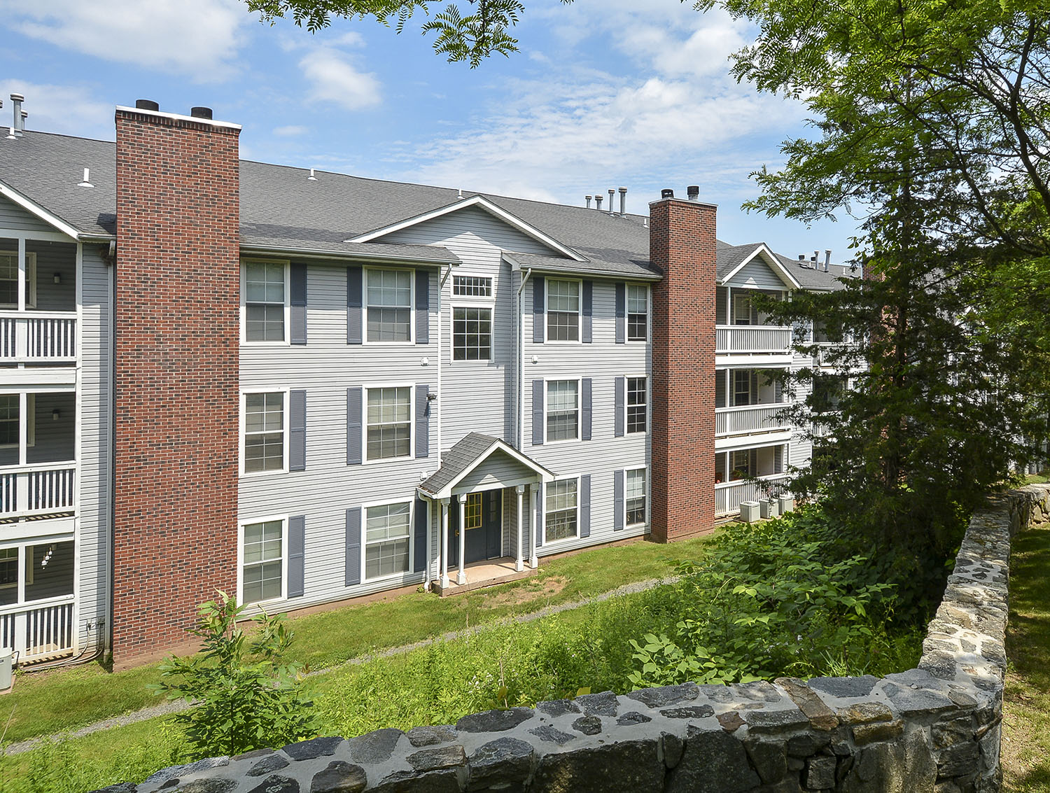 stone wall with apartments in the background 