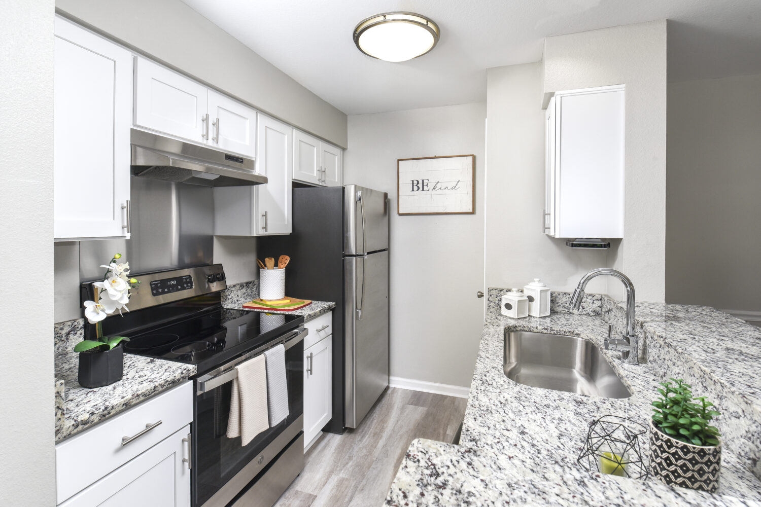 white kitchen cabinets, granite countertops and breakfast bar 