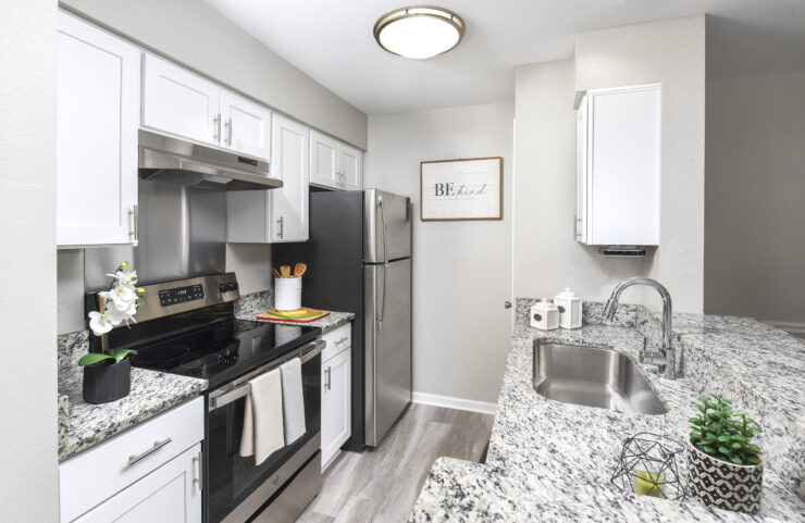 white kitchen cabinets, granite countertops and breakfast bar 