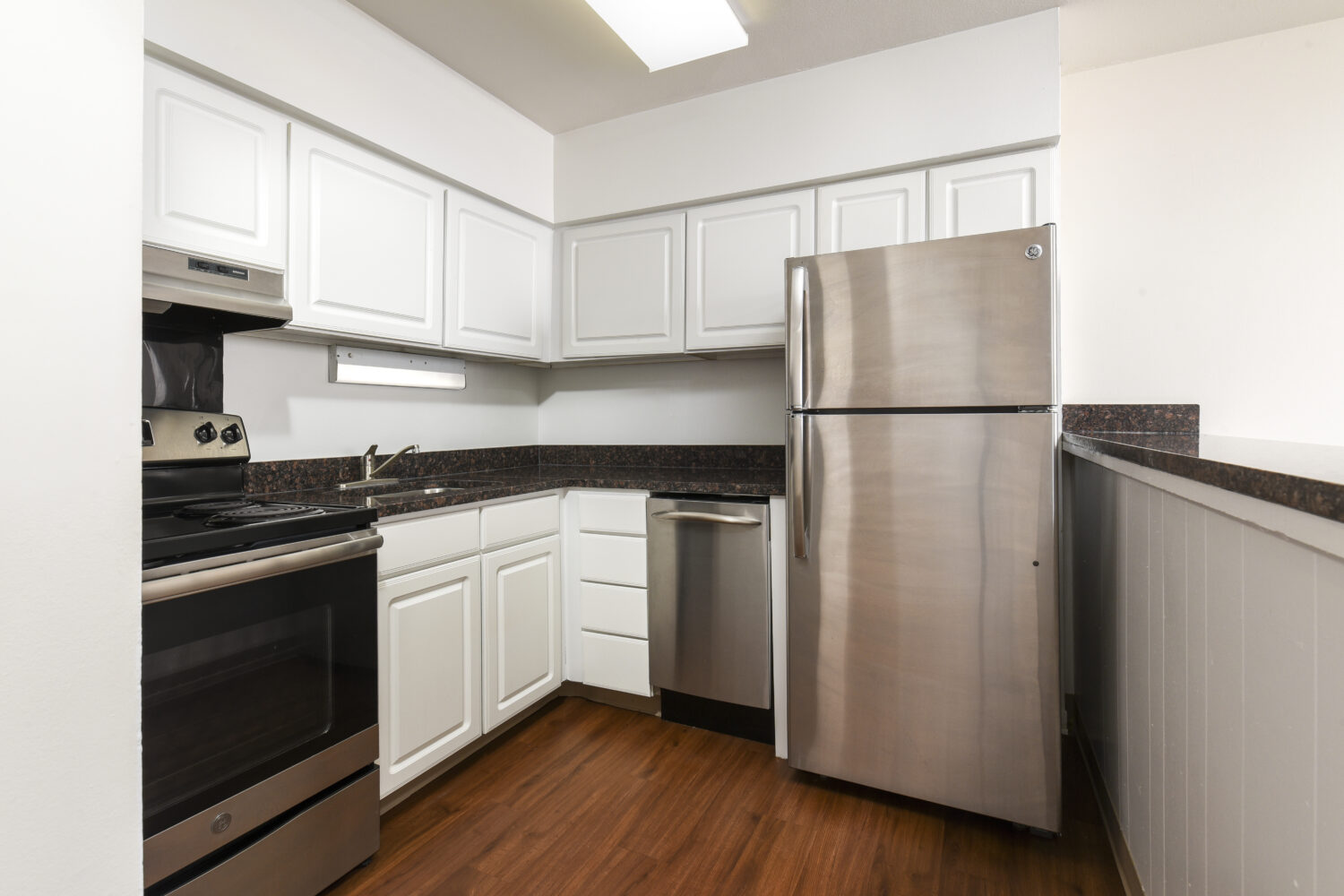 kitchen with white cabinets and plank flooring